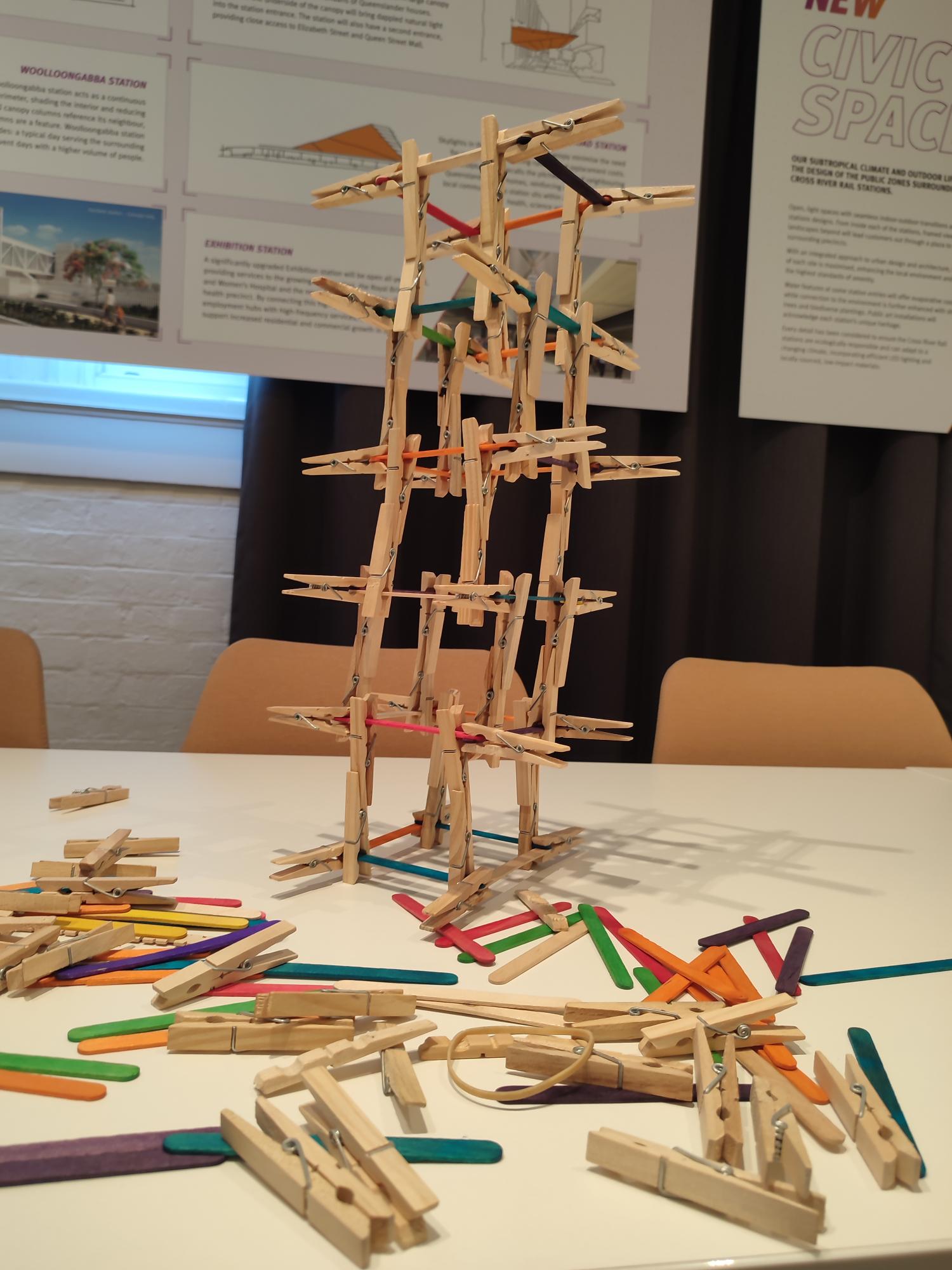 Building structure made oyr if wooden clothes pegs and coloured craft sticks.