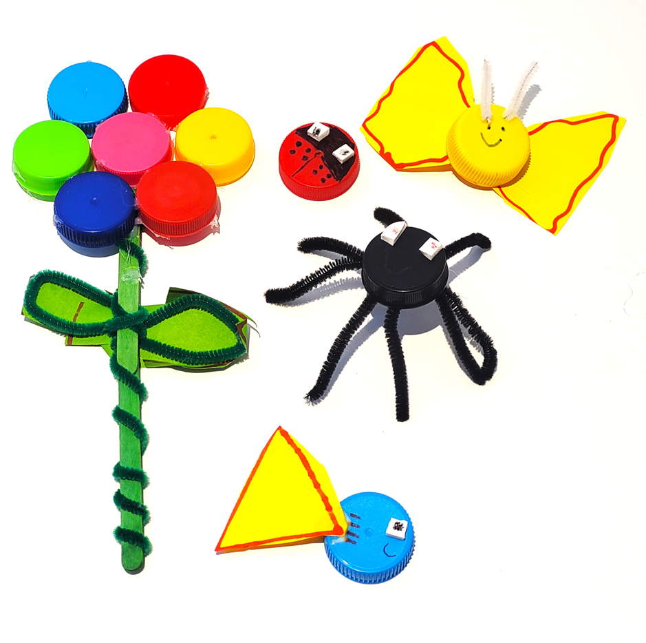 A flower, a spider and a butterfly made from bottle cpas and other craft materials.